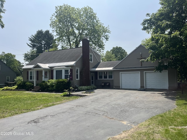 6 Pine Rd, Moreau, NY 12803 - view of front of home featuring a garage, driveway, a front yard, and a chimney