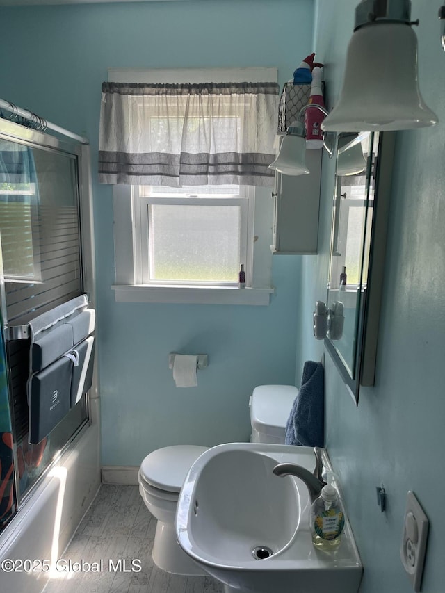 6 Pine Rd, Moreau, NY 12803 - bathroom featuring healthy amount of natural light, a sink, toilet, and bath / shower combo with glass door