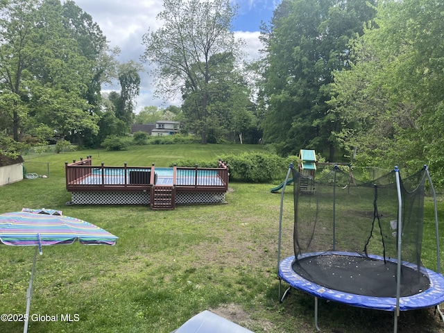 6 Pine Rd, Moreau, NY 12803 - view of green lawn with a trampoline and a deck
