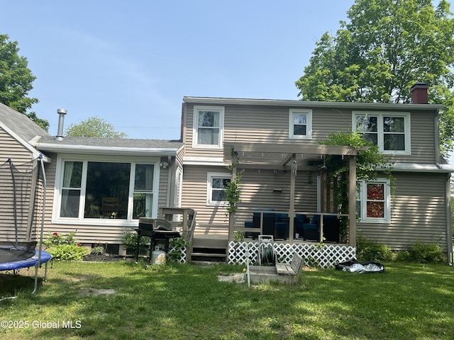 6 Pine Rd, Moreau, NY 12803 - back of house featuring a chimney, a lawn, a deck, a trampoline, and a pergola