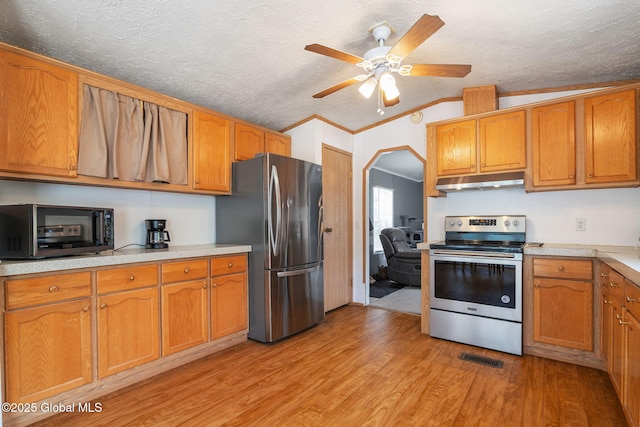 131 Abrams Rd, Wright, NY 12023 - kitchen with stainless steel appliances, under cabinet range hood, light wood-style floors, light countertops, and a textured ceiling