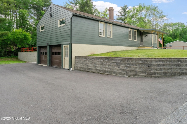 16 Smith Ln, East Greenbush, NY 12144 - view of front facade with a garage, a chimney, driveway, and a front lawn