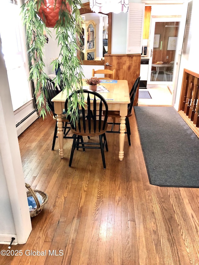 607 Gansevoort Rd, Moreau, NY 12803 - dining room featuring a baseboard radiator and wood finished floors