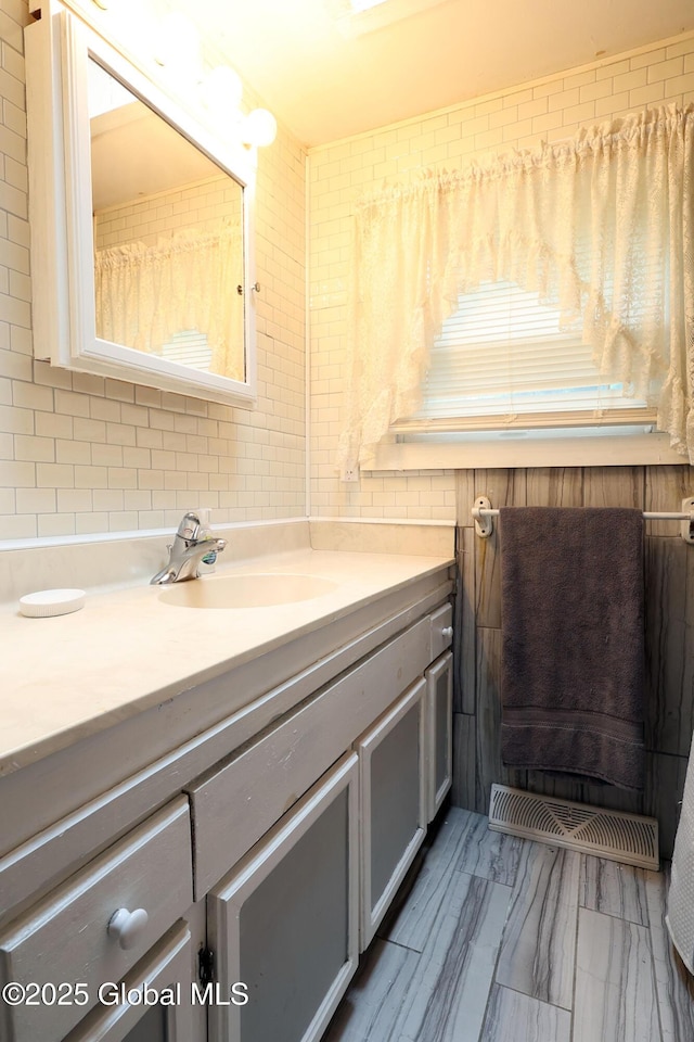 68 Elks Glade Rd, Chester, NY 12817 - bathroom with vanity, marble finish floors, and decorative backsplash