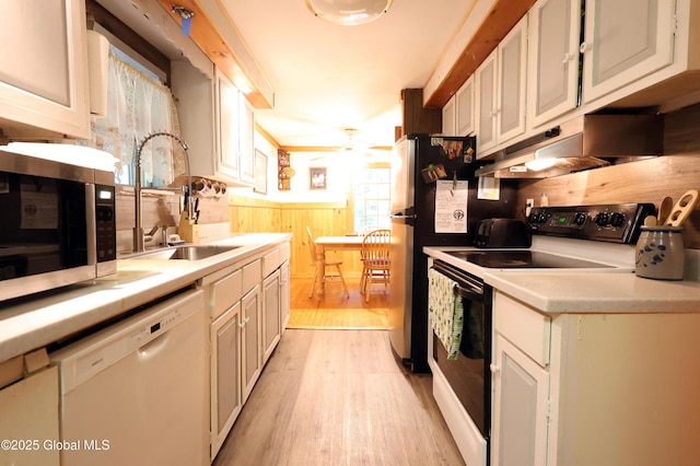 68 Elks Glade Rd, Chester, NY 12817 - kitchen featuring electric stove, white dishwasher, stainless steel microwave, a wainscoted wall, and light wood finished floors
