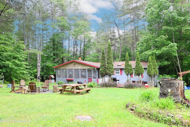 68 Elks Glade Rd, Chester, NY 12817 - view of grassy yard featuring a sunroom and an outdoor fire pit