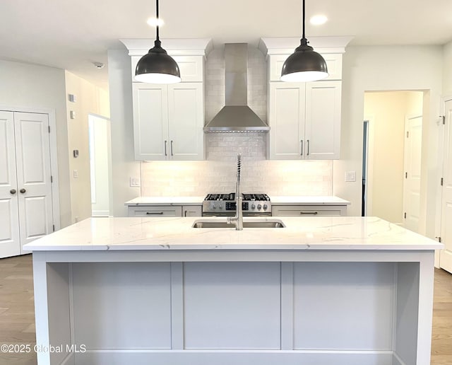 1 Jennifer Ln, Milton, NY 12020 - kitchen featuring wall chimney exhaust hood, tasteful backsplash, light wood finished floors, and light stone counters