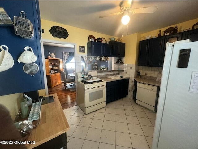 13 Hawk St, Amsterdam, NY 12010 - kitchen featuring white appliances, ceiling fan, light tile patterned floors, a sink, and decorative backsplash
