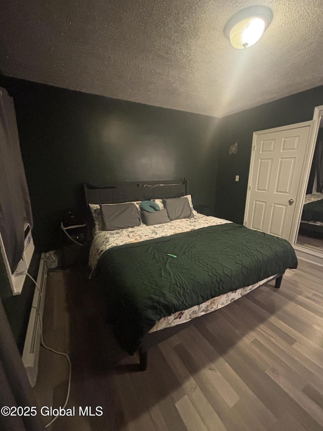 13 Hawk St, Amsterdam, NY 12010 - bedroom featuring wood finished floors and a textured ceiling