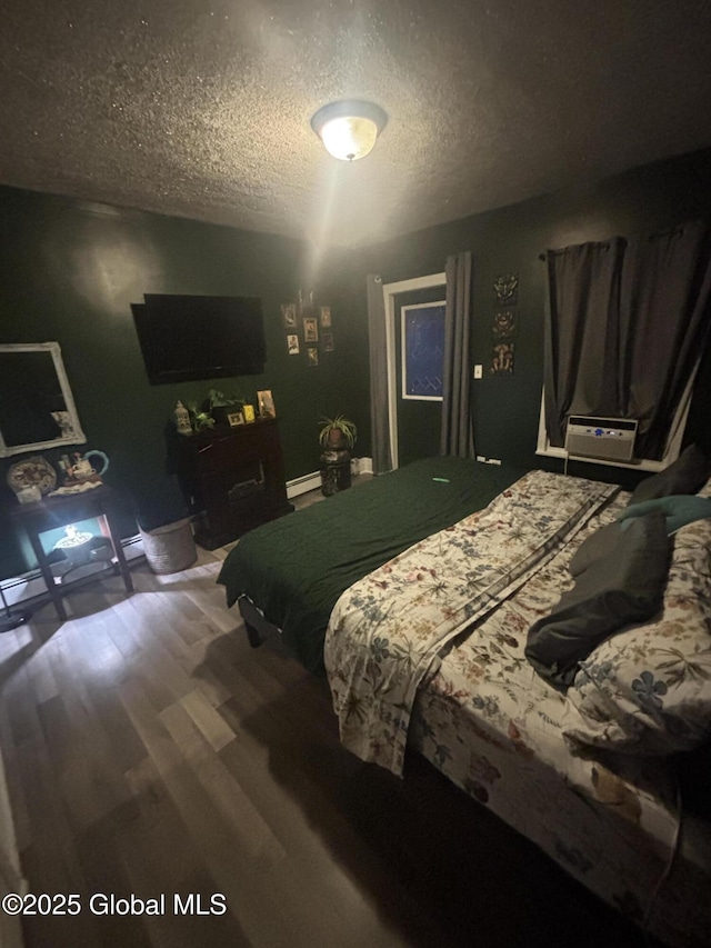 13 Hawk St, Amsterdam, NY 12010 - bedroom with wood finished floors, a textured ceiling, and baseboard heating