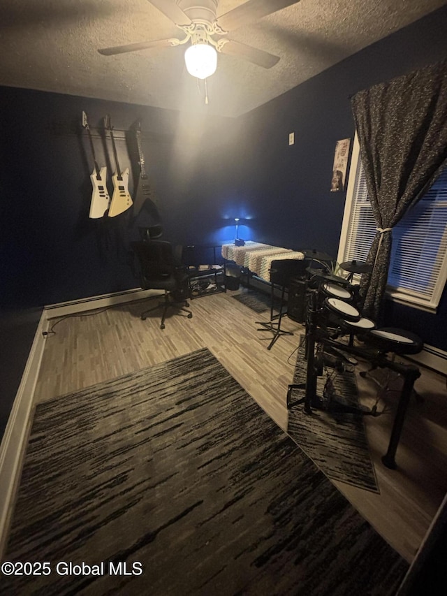 13 Hawk St, Amsterdam, NY 12010 - dining space featuring wood finished floors, a textured ceiling, a ceiling fan, and baseboards