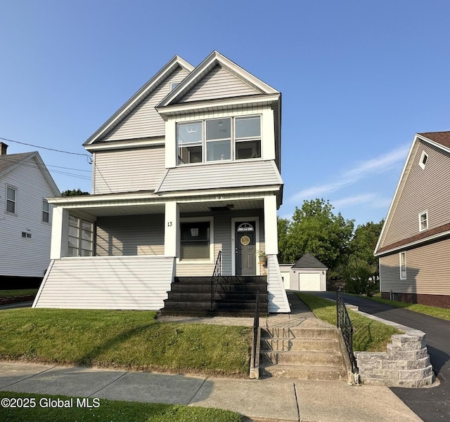 13 Hawk St, Amsterdam, NY 12010 - view of front of home with an outdoor structure, covered porch, and a detached garage