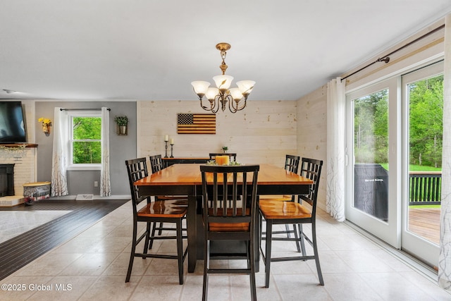 1396 Barton Hill Rd, Wright, NY 12053 - dining room with a chandelier, light tile patterned flooring, and a brick fireplace