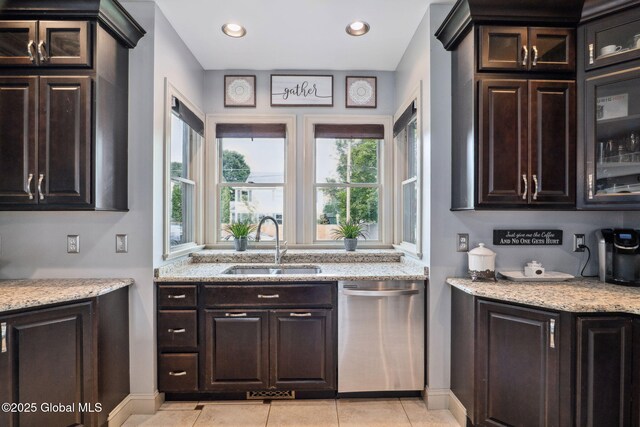 195 W Circular St, Saratoga Springs, NY 12866 - kitchen featuring dishwasher, glass insert cabinets, light stone counters, light tile patterned flooring, and dark brown cabinets