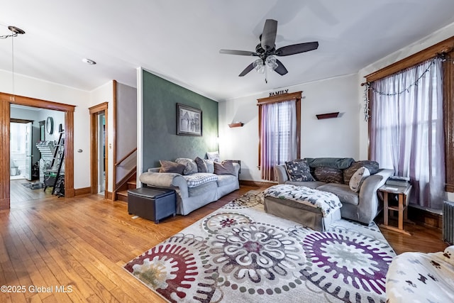 58 N Allen St, Albany, NY 12203 - living area with a ceiling fan, hardwood / wood-style floors, baseboards, stairway, and radiator heating unit