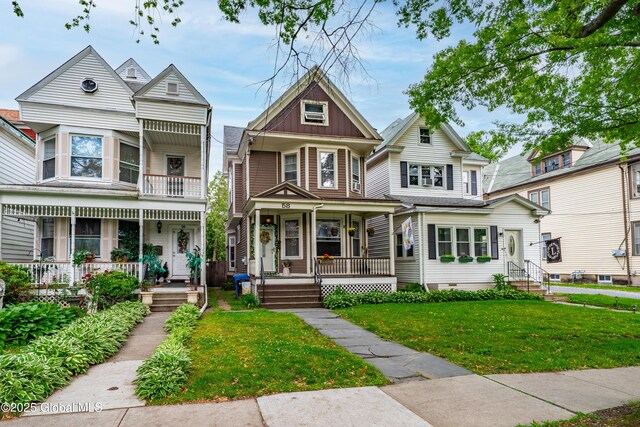 58 N Allen St, Albany, NY 12203 - victorian-style house with a porch, board and batten siding, and a front yard