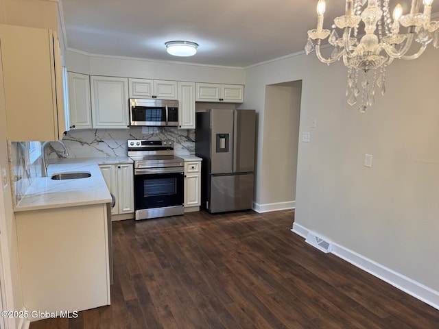 311 Old Loudon Rd, Colonie, NY 12110 - kitchen featuring stainless steel appliances, a sink, a chandelier, tasteful backsplash, and baseboards
