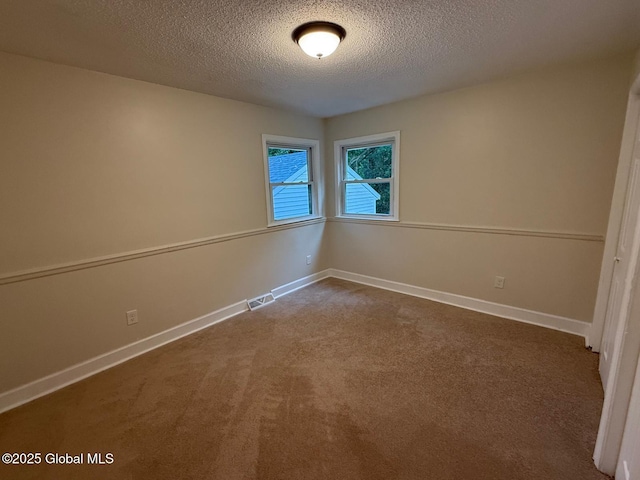 311 Old Loudon Rd, Colonie, NY 12110 - empty room with a textured ceiling, dark carpet, and baseboards
