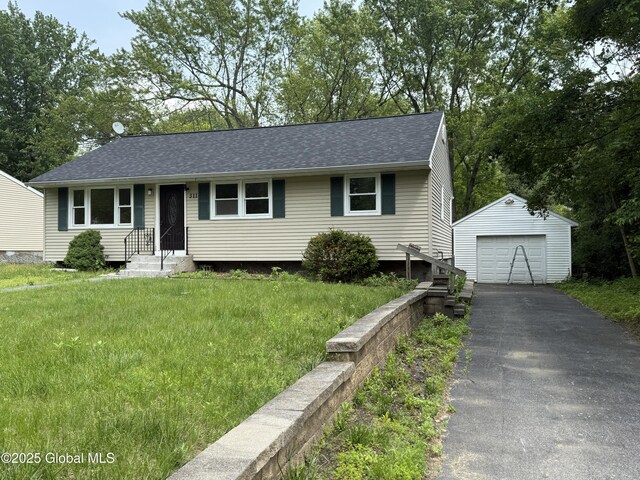 311 Old Loudon Rd, Colonie, NY 12110 - view of front of home featuring a detached garage, an outbuilding, asphalt driveway, and a shingled roof