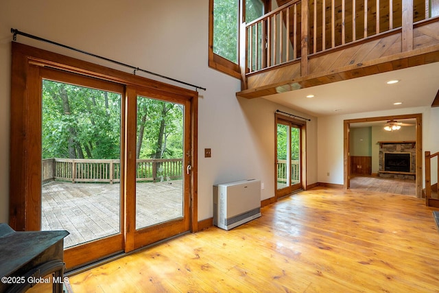 904 Ashgrove Rd, White Creek, NY 12816 - doorway with a fireplace, heating unit, ceiling fan, baseboards, and a high ceiling