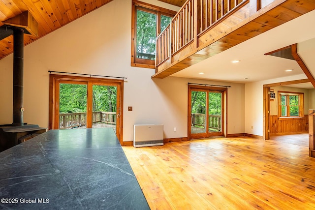 904 Ashgrove Rd, White Creek, NY 12816 - unfurnished living room featuring a wood stove, hardwood / wood-style floors, recessed lighting, baseboards, and plenty of natural light