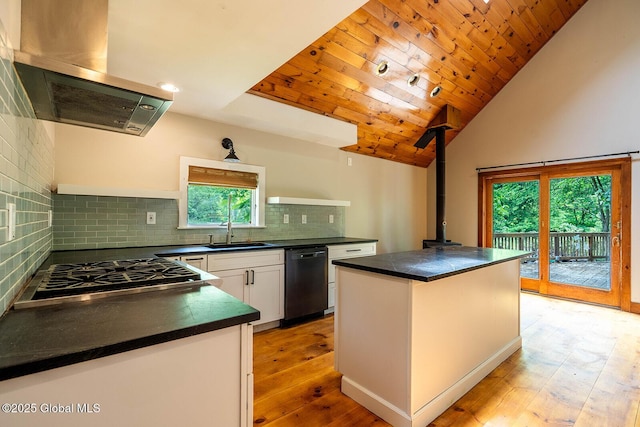 904 Ashgrove Rd, White Creek, NY 12816 - kitchen featuring island range hood, dishwasher, a wood stove, dark countertops, and white cabinetry