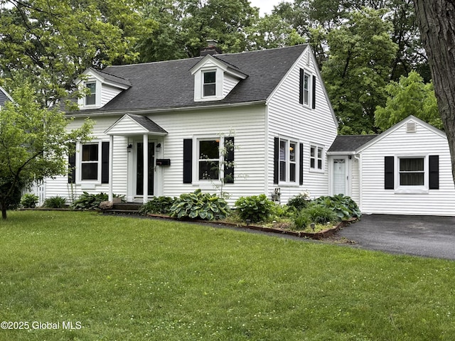1922 Regent St, Niskayuna, NY 12309 - cape cod home featuring a front yard, roof with shingles, a chimney, and view of scattered trees