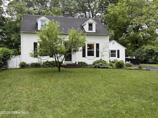 1922 Regent St, Niskayuna, NY 12309 - cape cod-style house featuring a chimney, view of wooded area, and a shingled roof