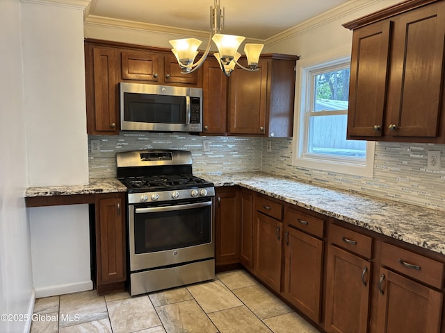 1922 Regent St, Niskayuna, NY 12309 - kitchen featuring appliances with stainless steel finishes, a chandelier, crown molding, decorative backsplash, and light stone countertops