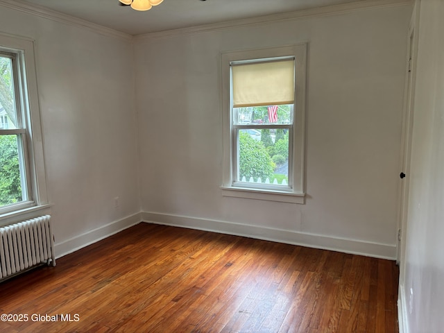 1922 Regent St, Niskayuna, NY 12309 - empty room with radiator heating unit, wood-type flooring, and crown molding