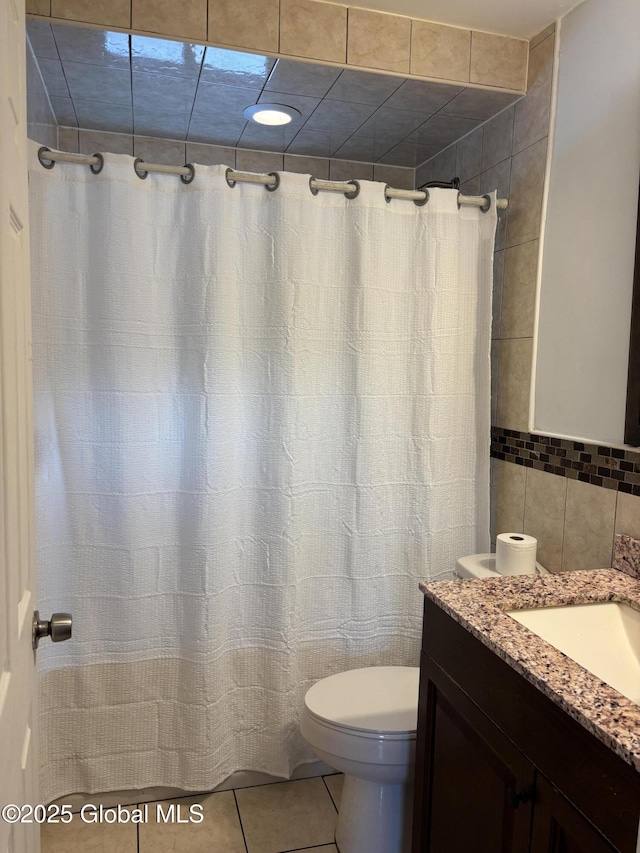 1922 Regent St, Niskayuna, NY 12309 - full bath featuring tile patterned flooring, tile walls, vanity, and a shower with curtain