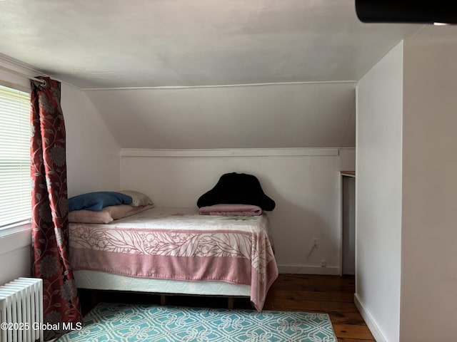 1922 Regent St, Niskayuna, NY 12309 - bedroom with radiator, wood finished floors, multiple windows, and lofted ceiling