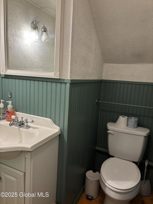 1922 Regent St, Niskayuna, NY 12309 - half bathroom featuring vanity, wainscoting, and a decorative wall