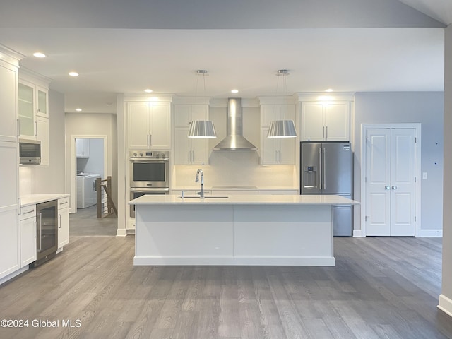 2 Jennifer Ln, Milton, NY 12020 - kitchen with wall chimney exhaust hood, a sink, appliances with stainless steel finishes, beverage cooler, and wood finished floors