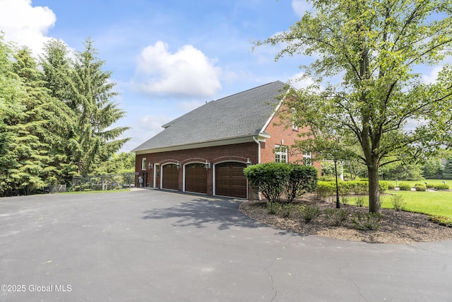1 Stoneridge Dr, Colonie, NY 12211 - view of home's exterior featuring brick siding, asphalt driveway, a shingled roof, and an attached garage