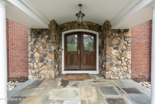 1 Stoneridge Dr, Colonie, NY 12211 - view of exterior entry with stone siding, brick siding, and french doors