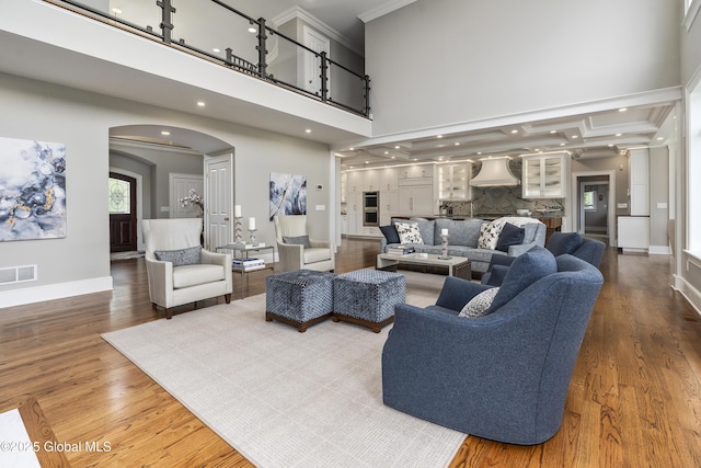 1 Stoneridge Dr, Colonie, NY 12211 - living room with arched walkways, ornamental molding, wood finished floors, recessed lighting, and a towering ceiling