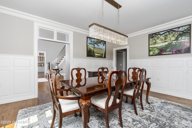 1 Stoneridge Dr, Colonie, NY 12211 - dining space featuring crown molding, wood finished floors, a decorative wall, a wainscoted wall, and stairway