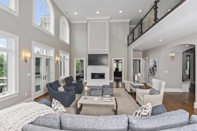 1 Stoneridge Dr, Colonie, NY 12211 - living room featuring a high ceiling, arched walkways, crown molding, wood finished floors, and recessed lighting