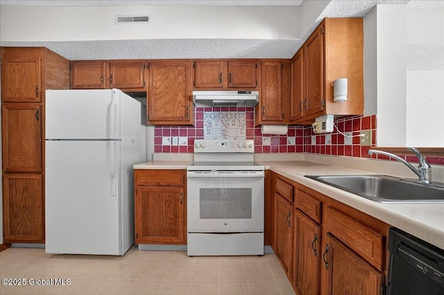 35 Justine Ct, East Greenbush, NY 12144 - kitchen featuring white appliances, under cabinet range hood, brown cabinets, light countertops, and tasteful backsplash