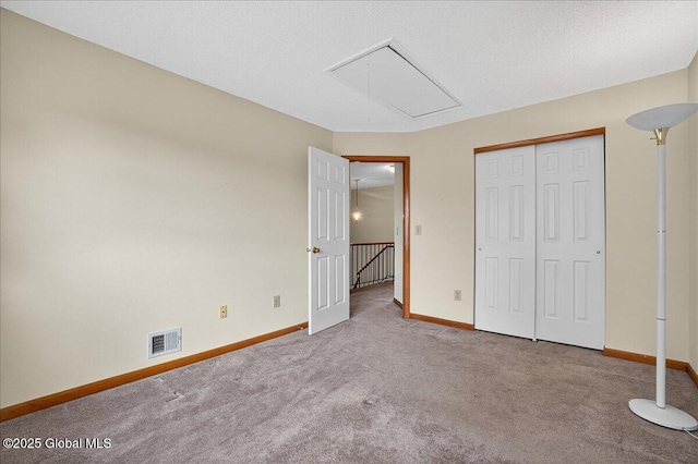 35 Justine Ct, East Greenbush, NY 12144 - unfurnished bedroom with attic access, carpet flooring, and a closet