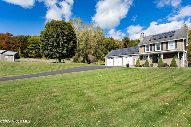 363 Goodman Rd, Fort Ann, NY 12827 - view of front of house featuring driveway, a chimney, a porch, roof mounted solar panels, and a garage