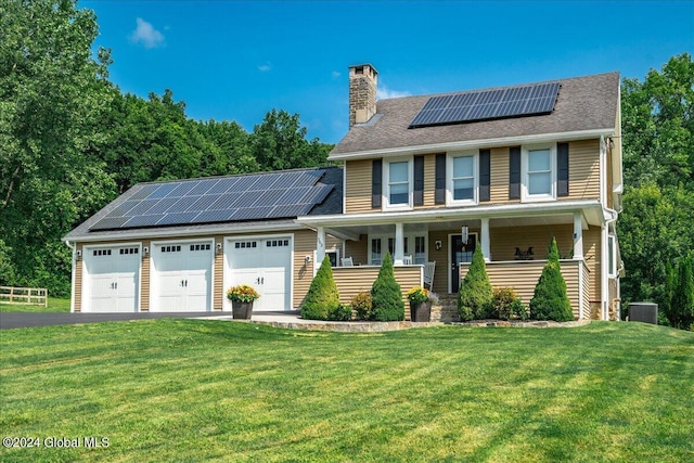 363 Goodman Rd, Fort Ann, NY 12827 - view of front of house with a porch, solar panels, an attached garage, a front yard, and a chimney
