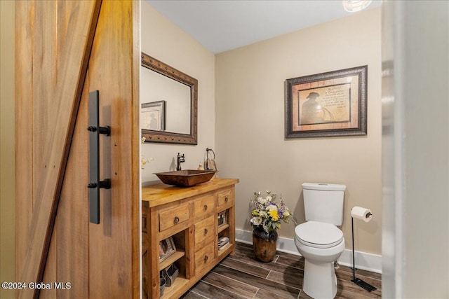 363 Goodman Rd, Fort Ann, NY 12827 - bathroom with toilet, vanity, wood finished floors, and baseboards