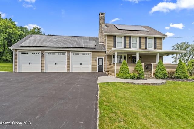 363 Goodman Rd, Fort Ann, NY 12827 - view of front of house featuring solar panels, covered porch, a front yard, a chimney, and asphalt driveway