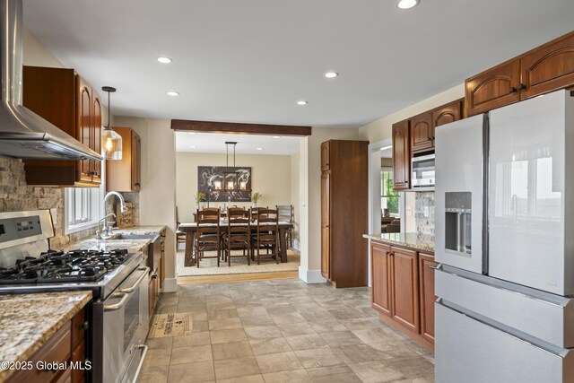 363 Goodman Rd, Fort Ann, NY 12827 - kitchen with gas stove, wall chimney range hood, white fridge with ice dispenser, tasteful backsplash, and recessed lighting