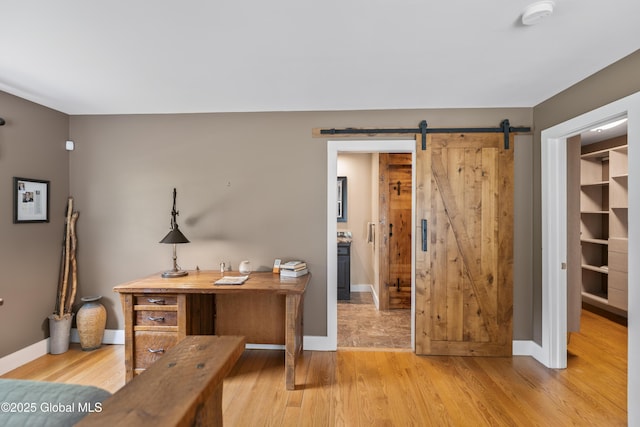 363 Goodman Rd, Fort Ann, NY 12827 - office area with light wood-type flooring, a barn door, and baseboards
