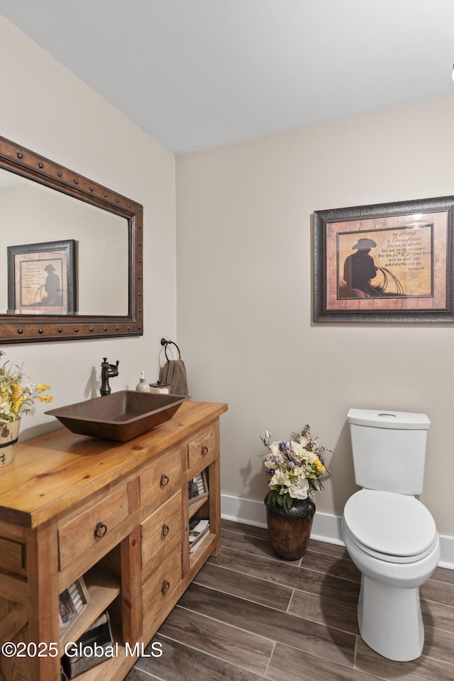 363 Goodman Rd, Fort Ann, NY 12827 - bathroom featuring vanity, toilet, wood finished floors, and baseboards