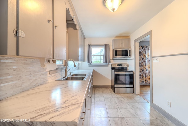 1298 Mcclellan St, Schenectady, NY 12309 - kitchen featuring appliances with stainless steel finishes, light countertops, backsplash, and light marble finish floors