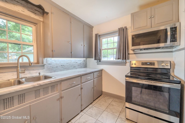 1298 Mcclellan St, Schenectady, NY 12309 - kitchen featuring appliances with stainless steel finishes, light countertops, and backsplash